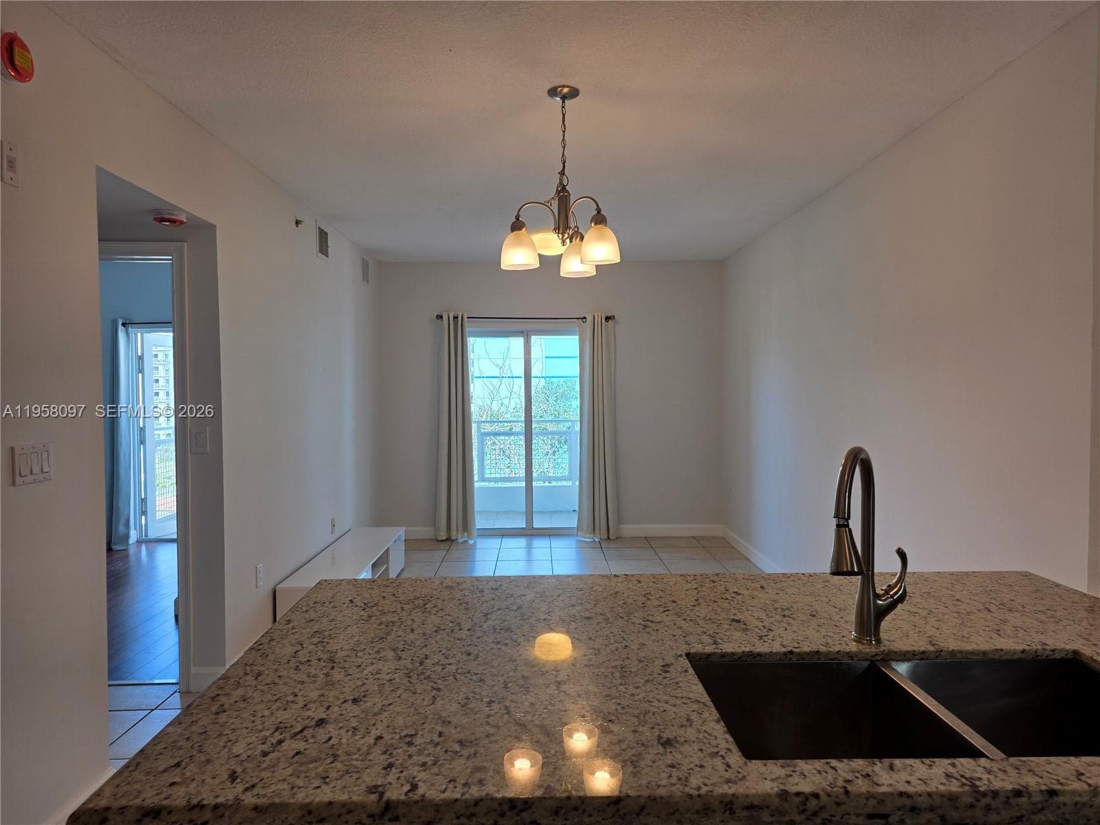 Granite breakfast bar with under-mount sink and modern faucet, ideal for casual dining or entertaining.
