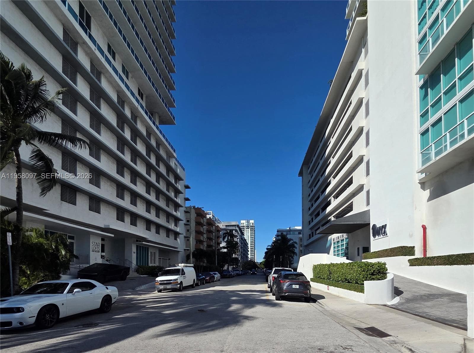 Quiet residential street with nearby luxury towers, showcasing the vibrant urban setting.