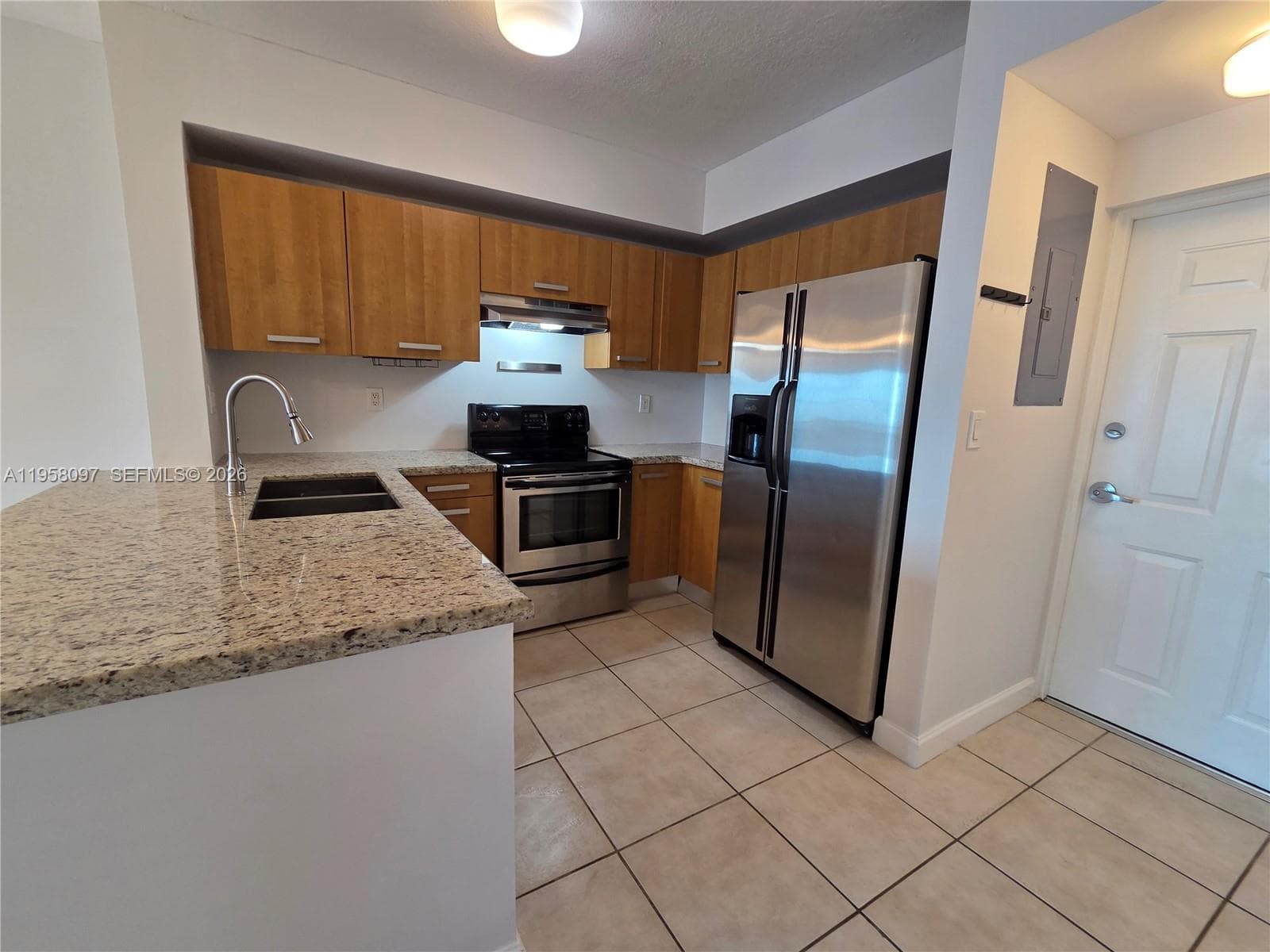 Open-concept kitchen positioned near the entry foyer for practical everyday living.