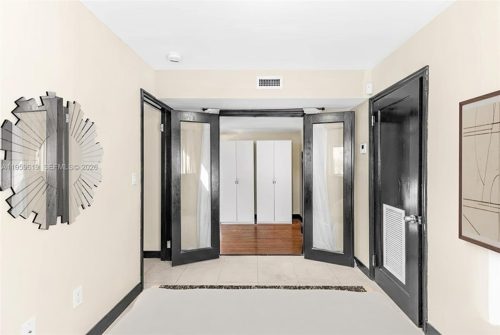 second bedroom with doors opening  to living area