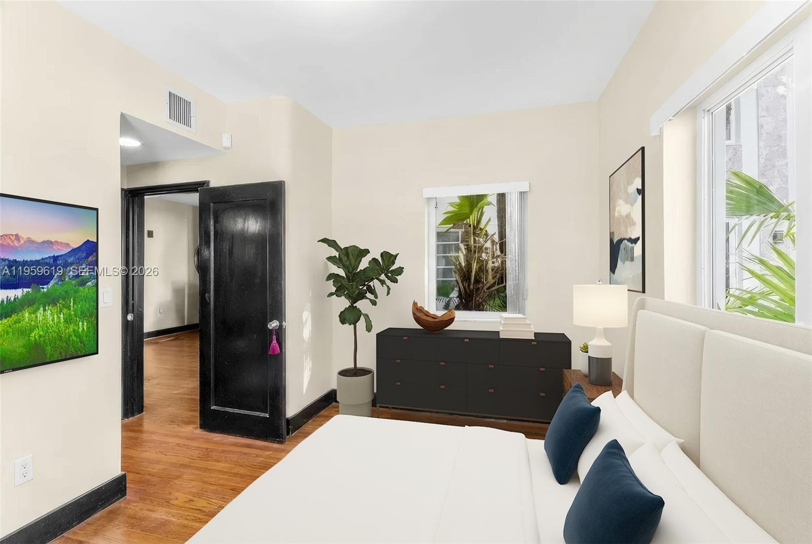 bedroom with hallway leading to en suite bath