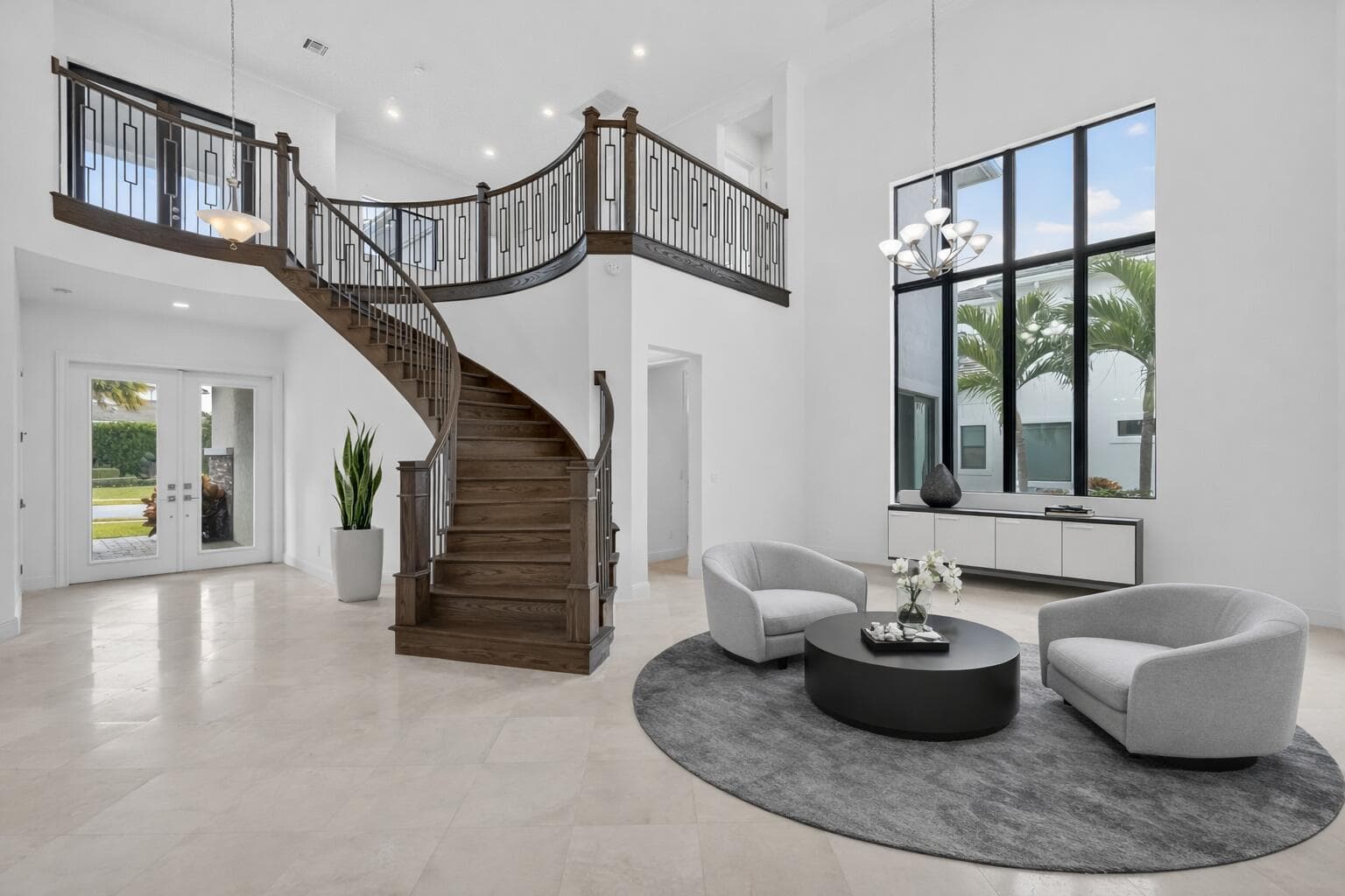 Modern foyer with curved staircase and s