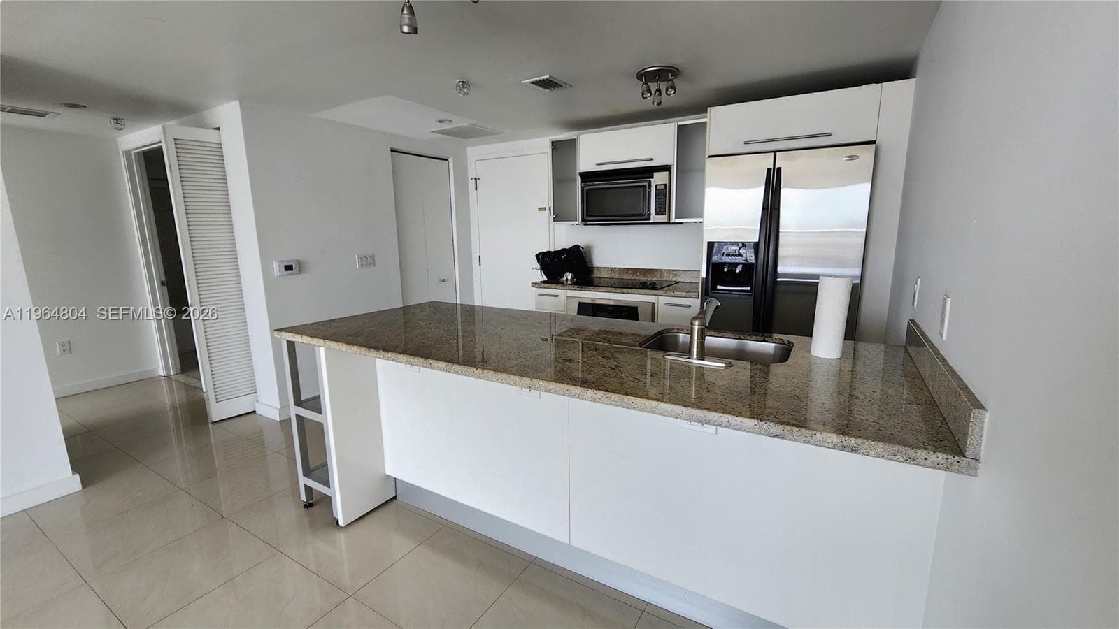 Stainless steel appliances. Granite countertop with dinning area, just add your high counter/bar stools