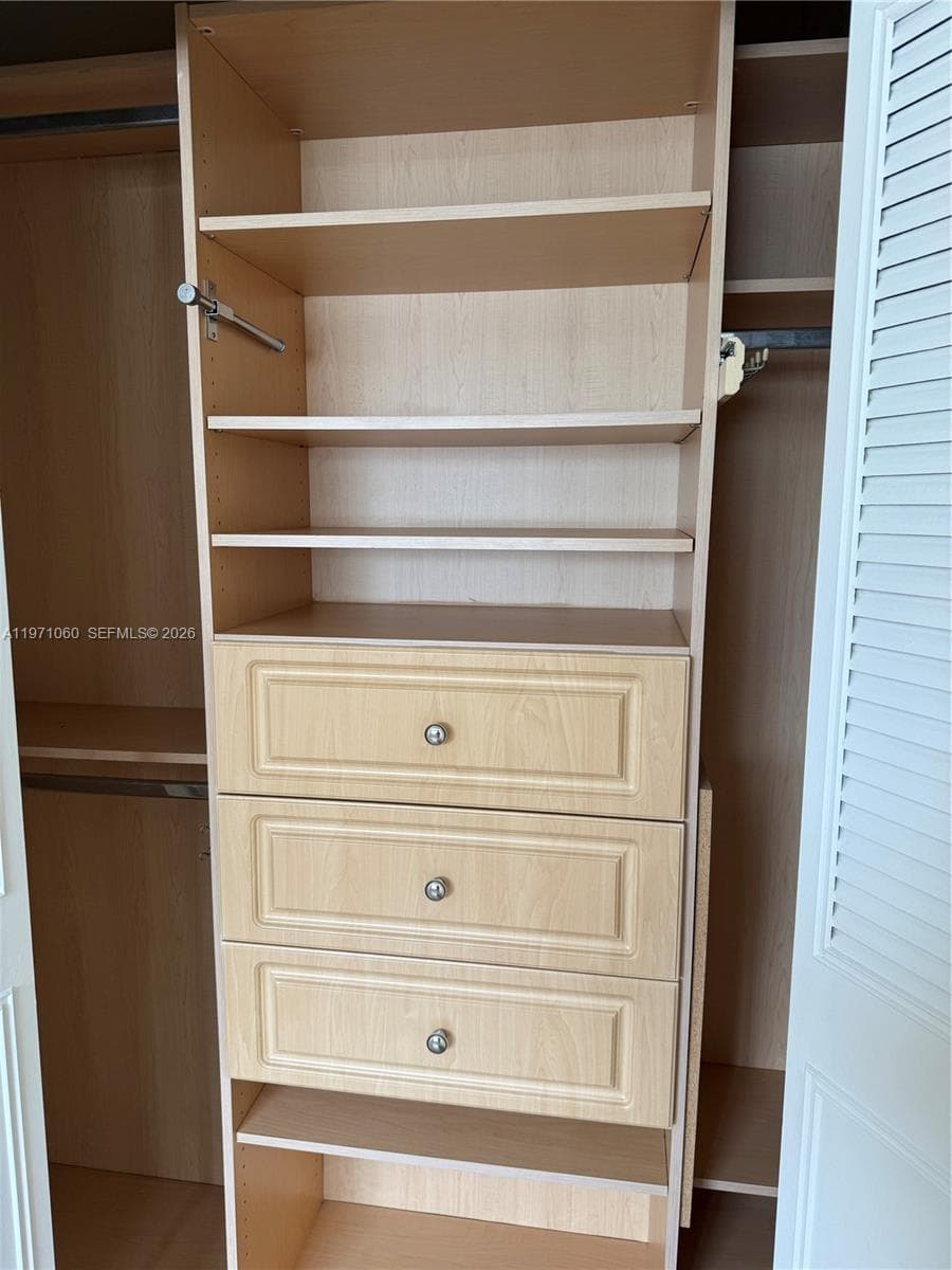 Master Bedroom closet finished with drawers and shelves