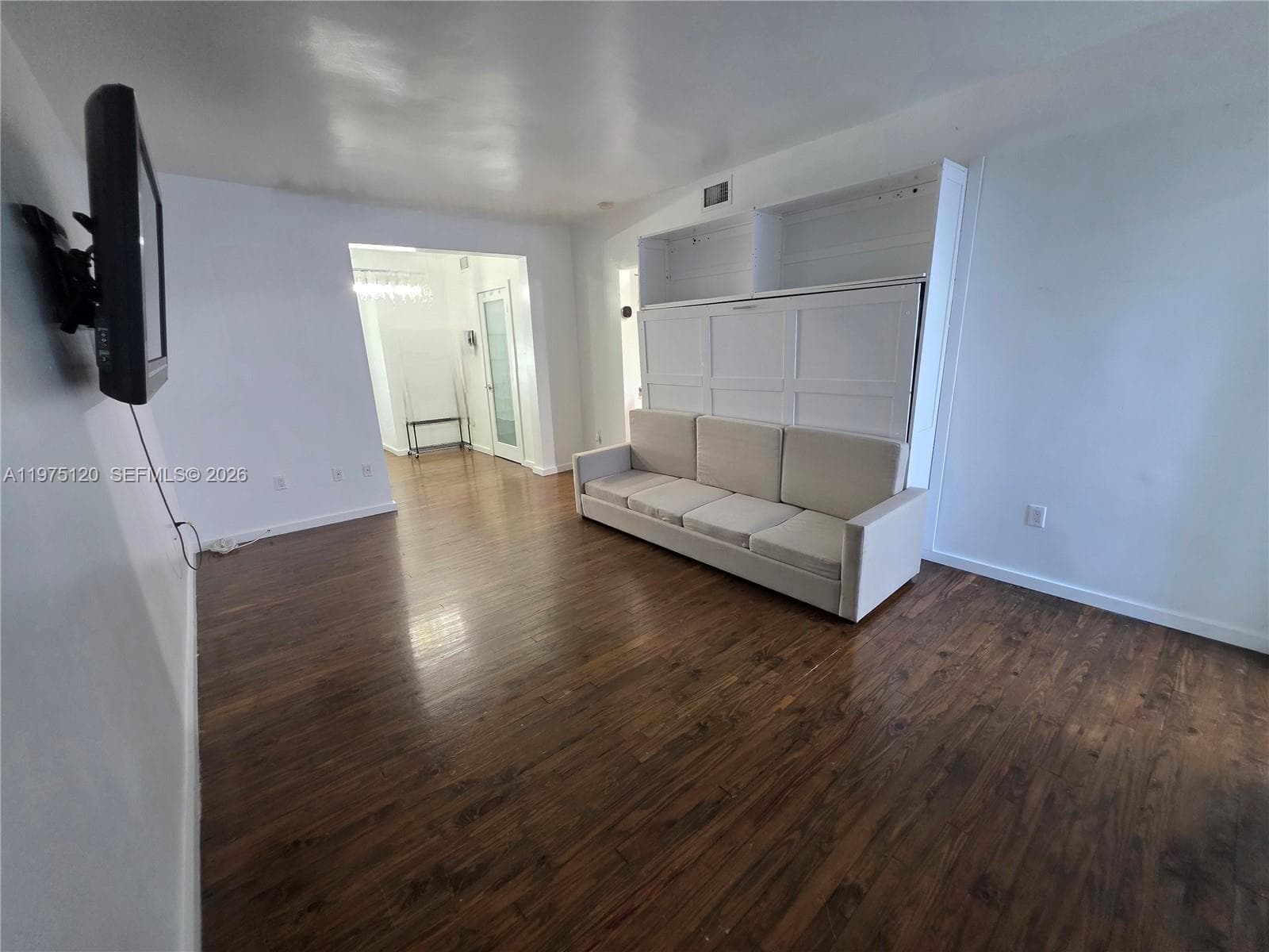 Main area living-bedroom area. Murphy bed and wall TV