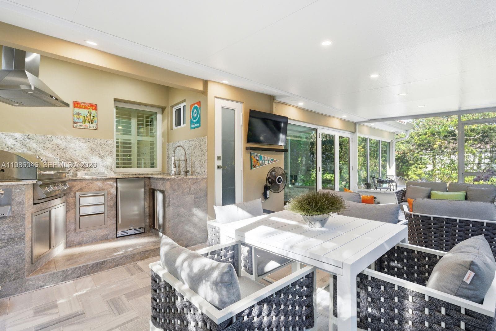 EXTERIOR BACK PATIO WITH BUILT IN BARBECUE AND HALF BATHROOM