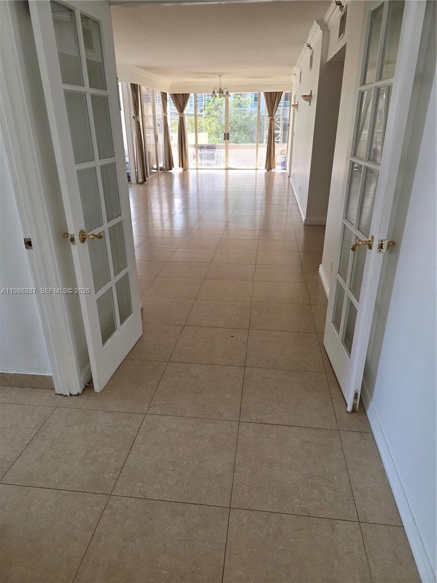 living area/doors lead to primary bedroom
