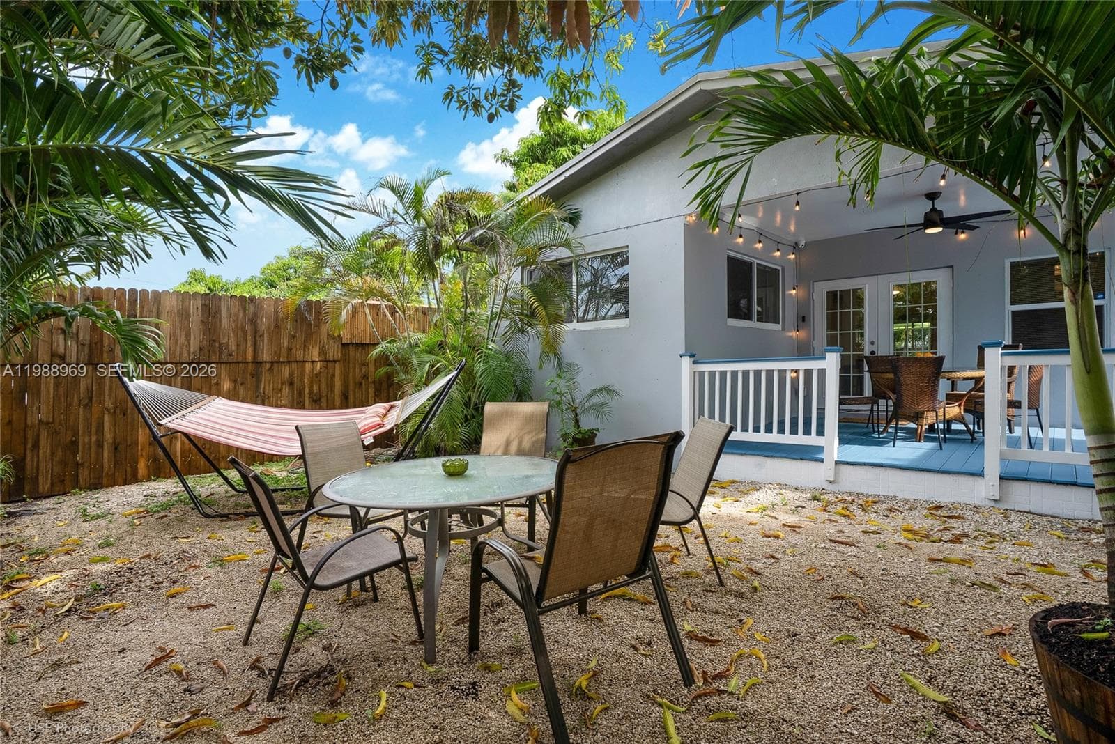 Private fenced in backyard under a huge mango tree.
