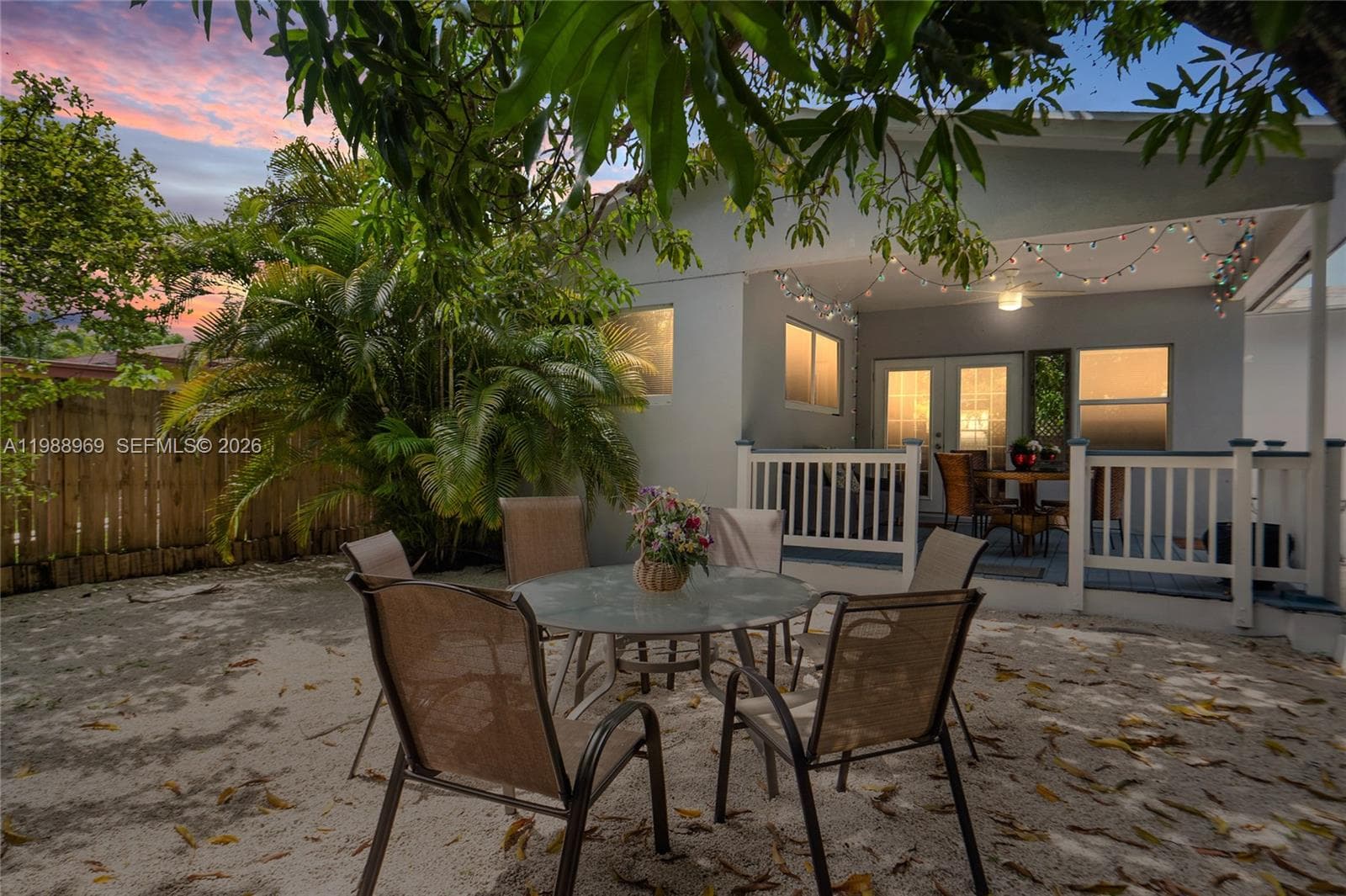 Private fenced in backyard under a huge mango tree.