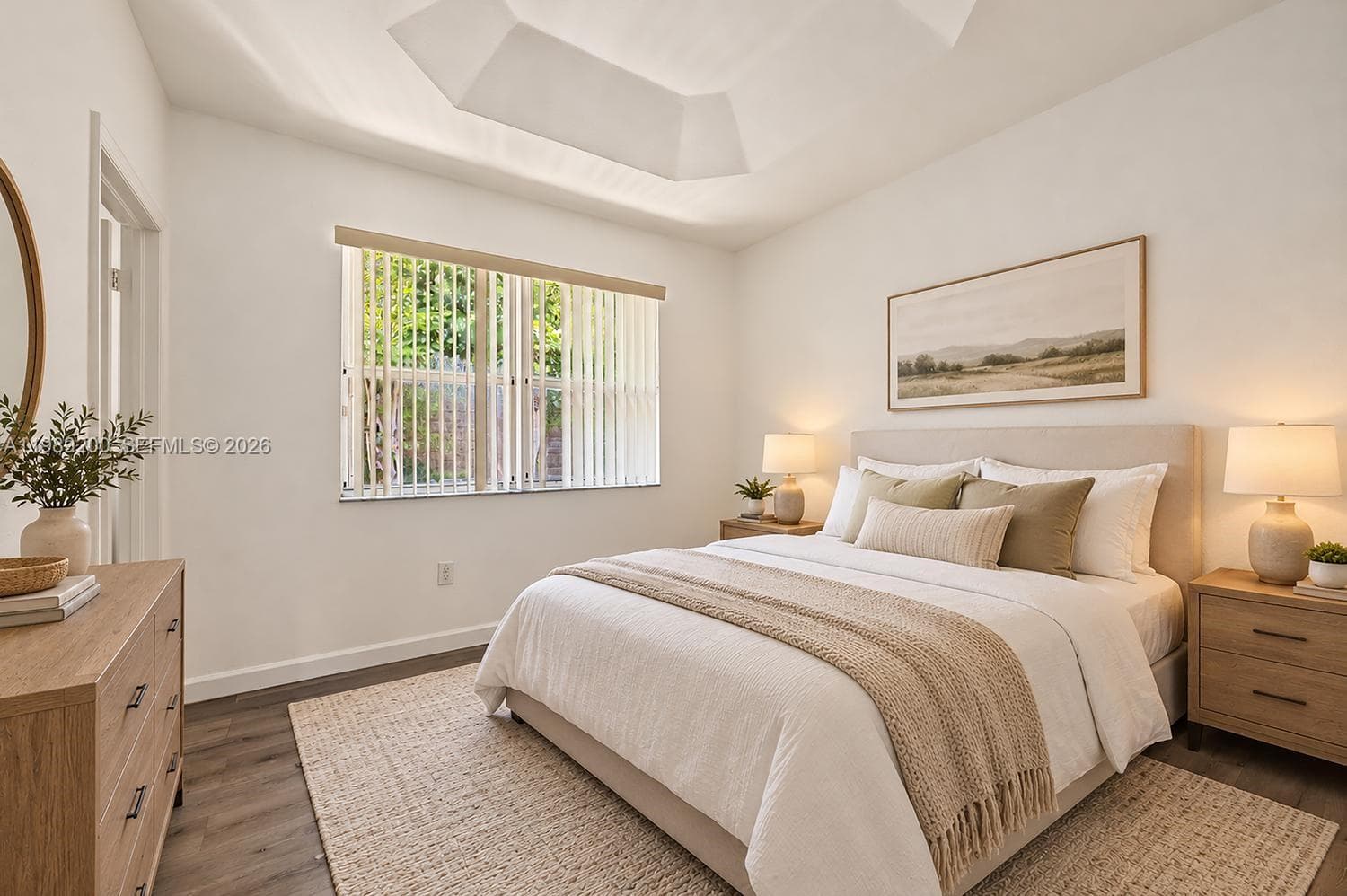 Tray ceiling, neutral wall color, and wood-finish flooring