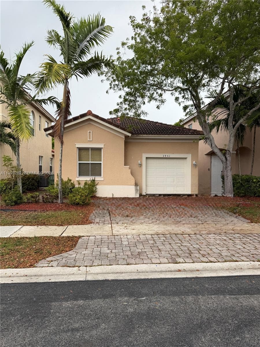 This photo shows the 1-car garage and 2-car front driveway.