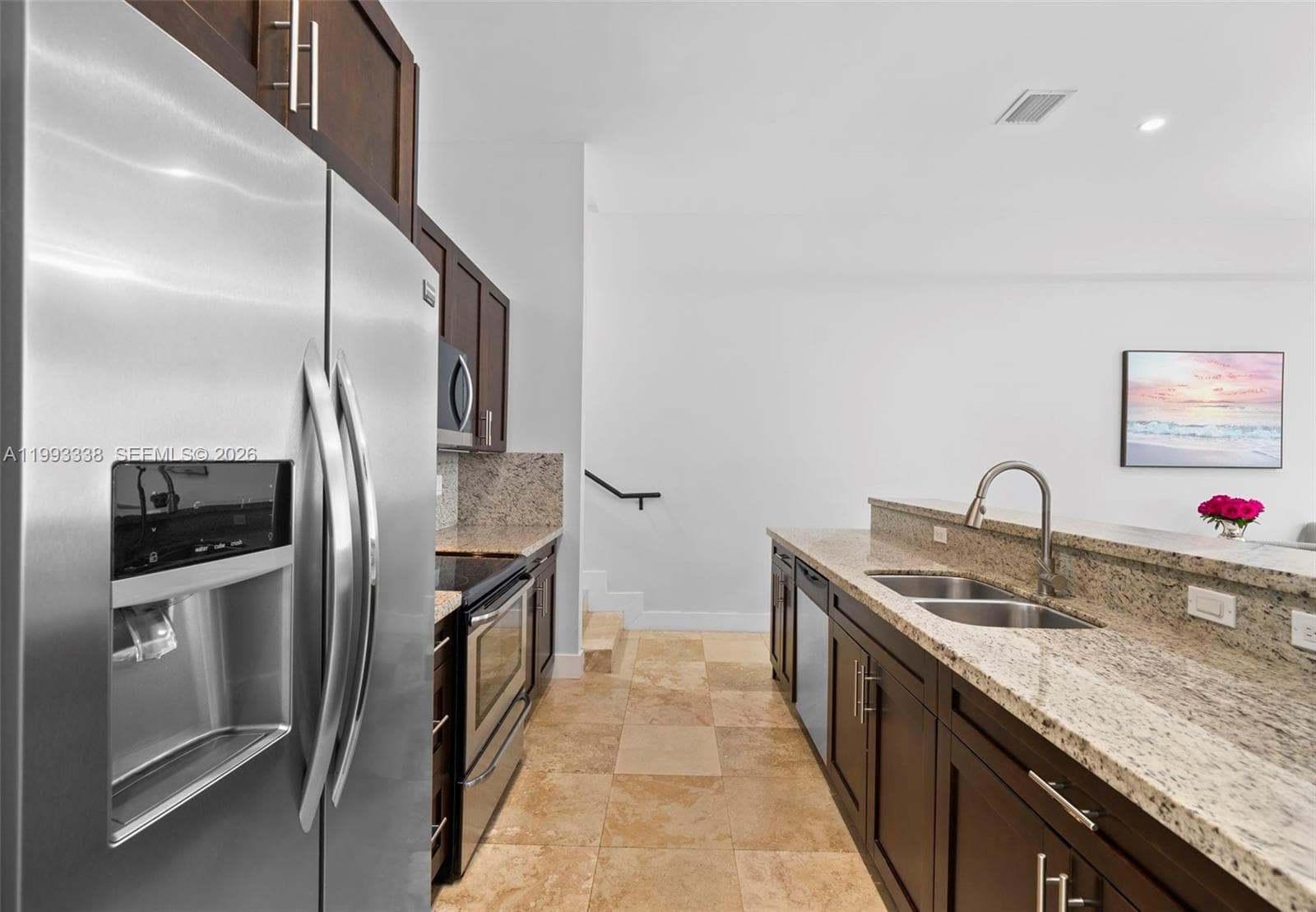 Gourmet kitchen with granite countertops and breakfast bar.