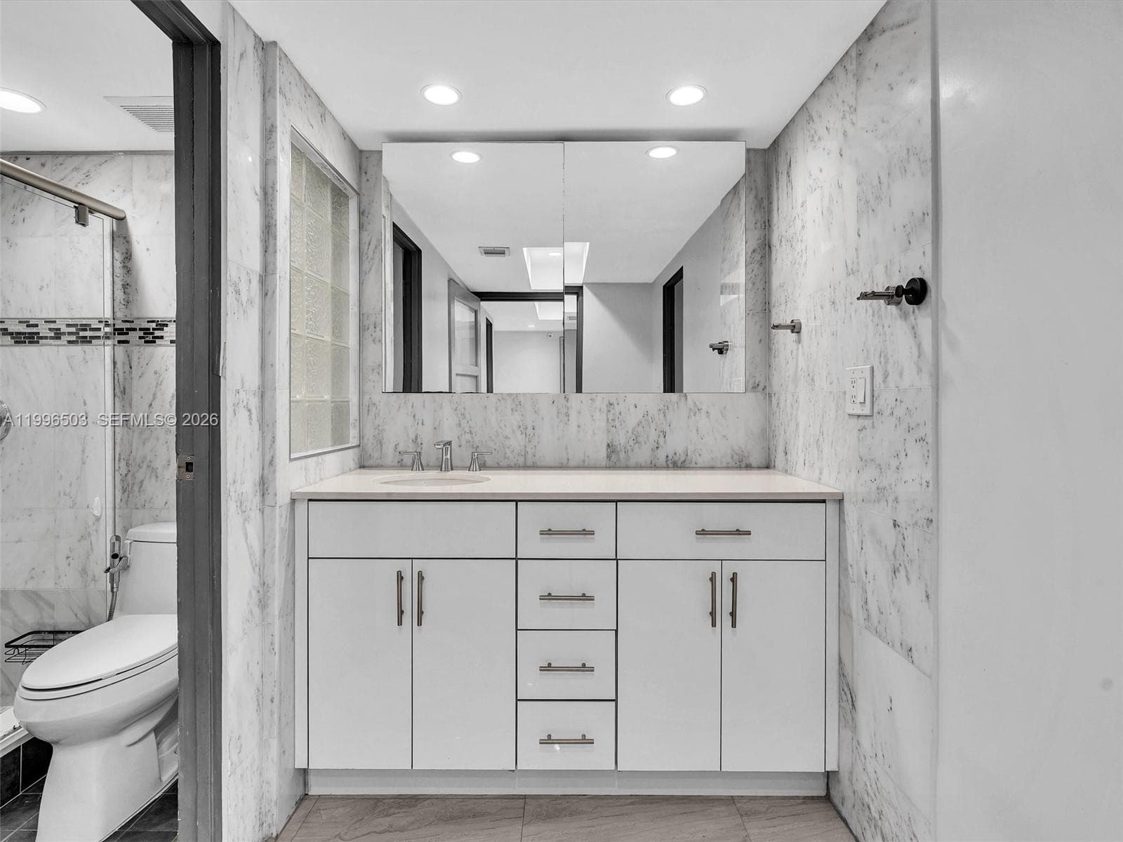 Spacious vanity area with separate shower and toilet room