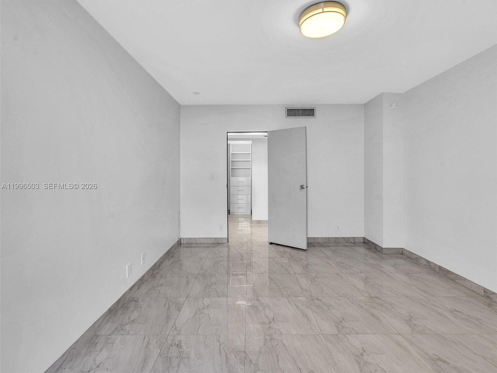 Bedroom with walk-in closet located across