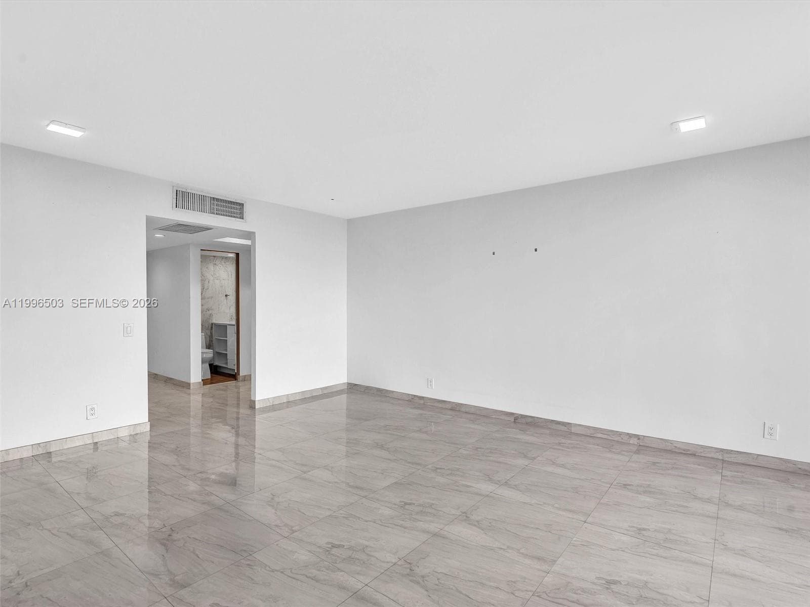 Living room with view toward entry and hallway