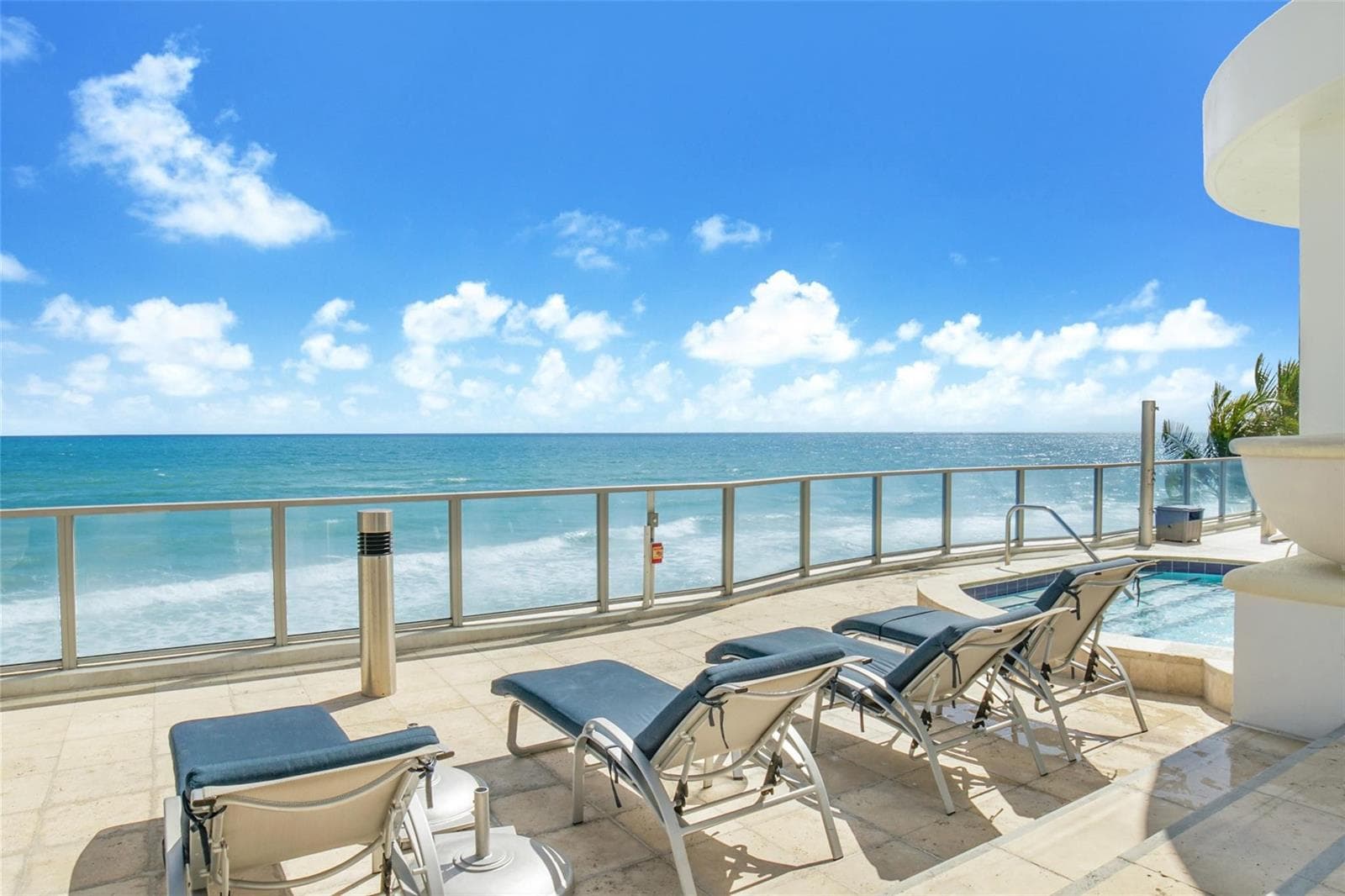Chaises by the ocean and hot tub
