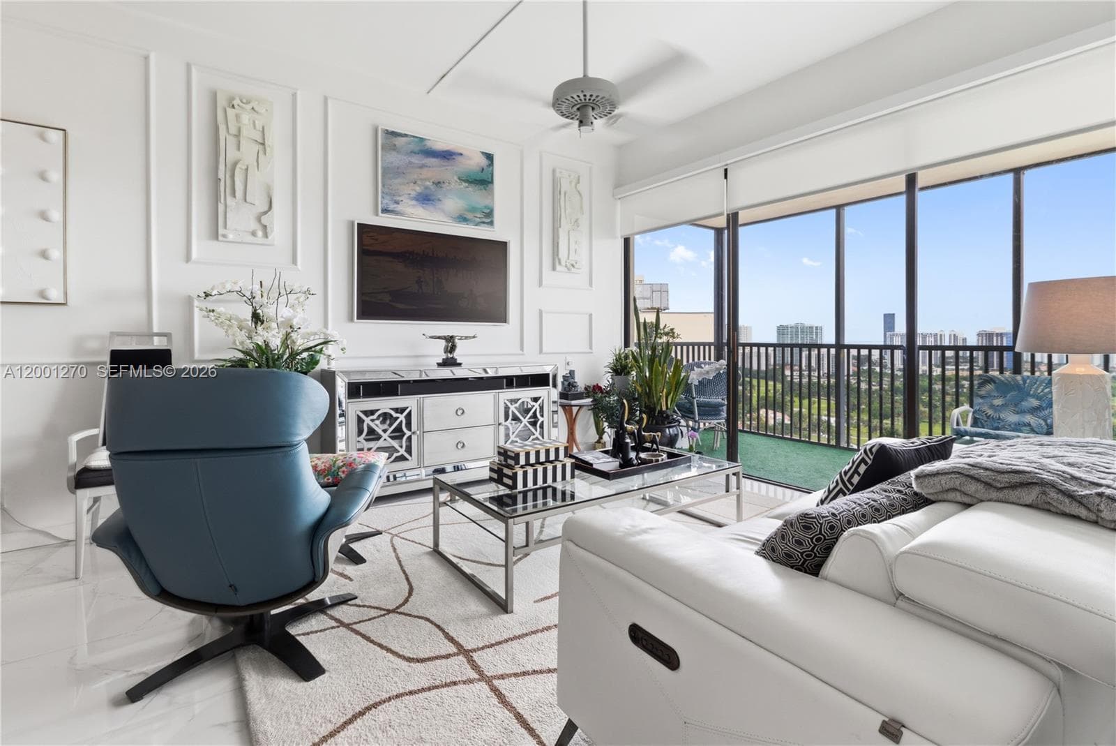 Bright living area with high ceilings and skyline views