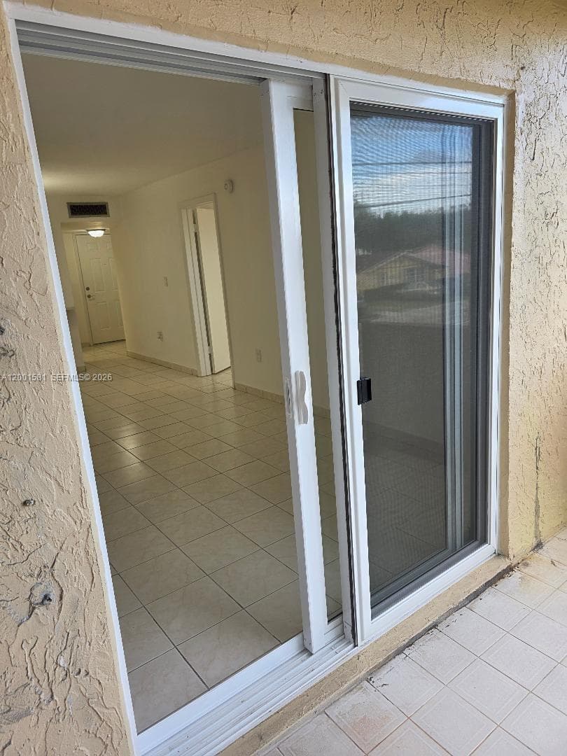 IMPACT SLIDING DOORS LEADING TO OPEN BALCONY