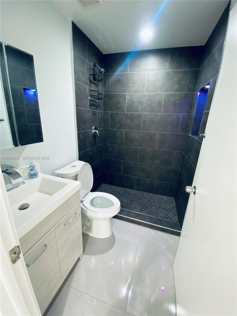 Master bedroom with walk in closet and en suite bathroom
