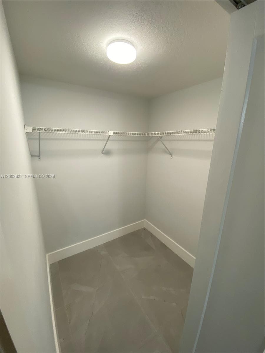 Master bedroom with walk in closet and en suite bathroom