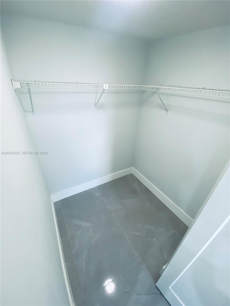Master bedroom with walk in closet and en suite bathroom