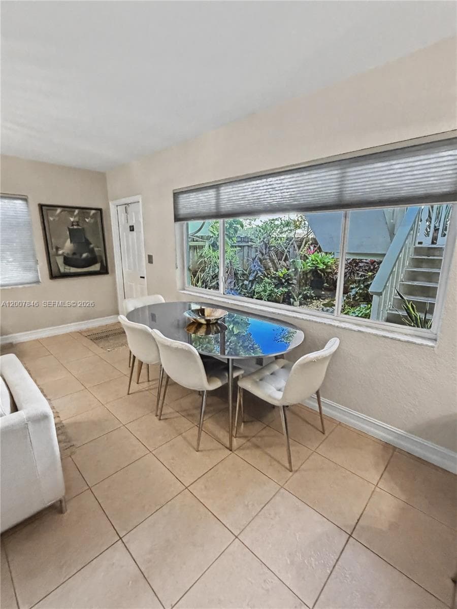 Bright dining area with large windows and modern fixtures — open to the kitchen