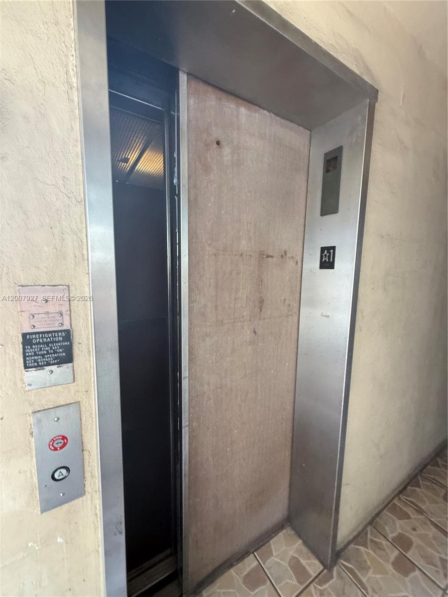 Elevator with brushed stainless steel frame and floor indicator