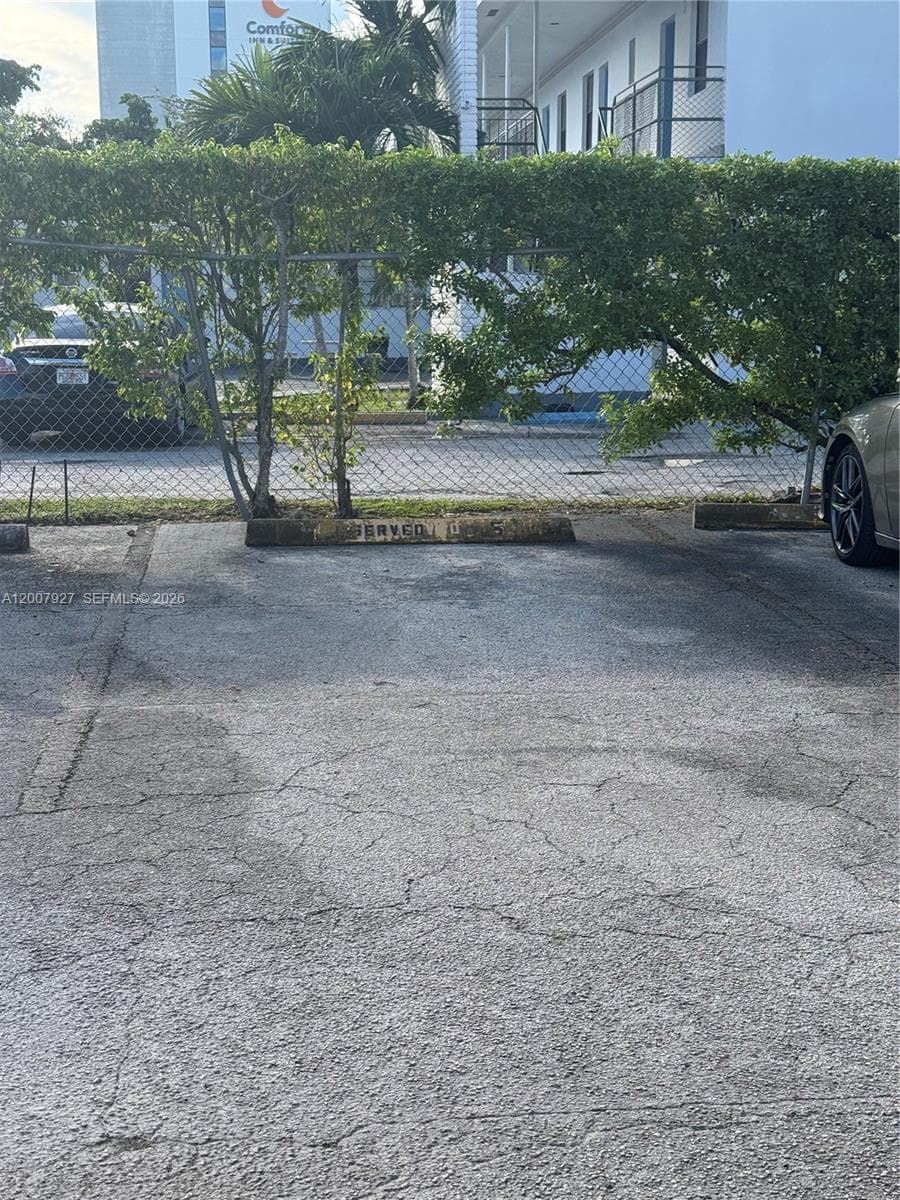 Designated surface parking space featuring a concrete parking stop