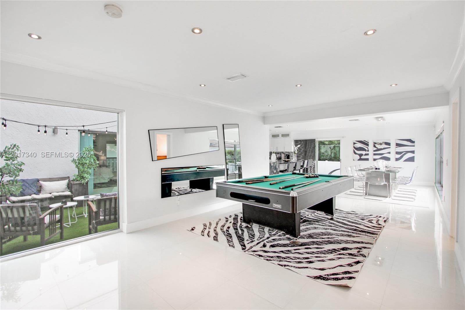 Large-format tile flooring, recessed ceiling lighting, and built-in wall-mounted mirror