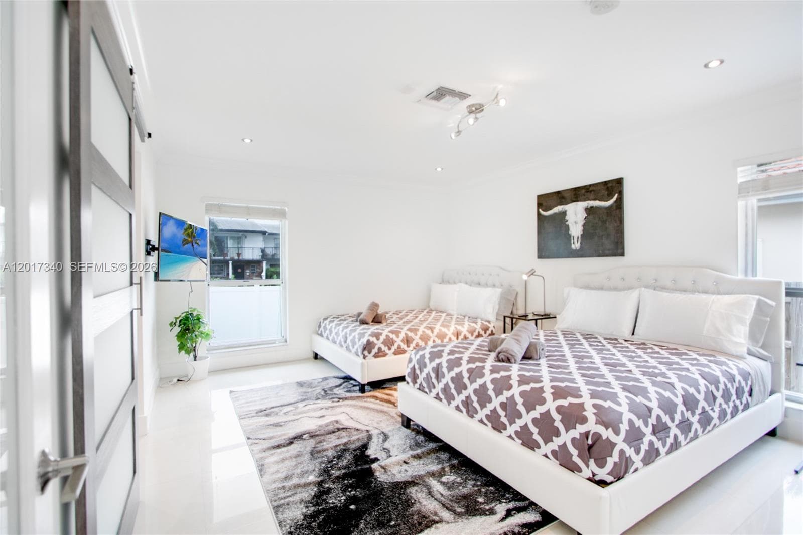Interior space featuring recessed lighting, smooth surface flooring, and a sliding door with frosted glass panels