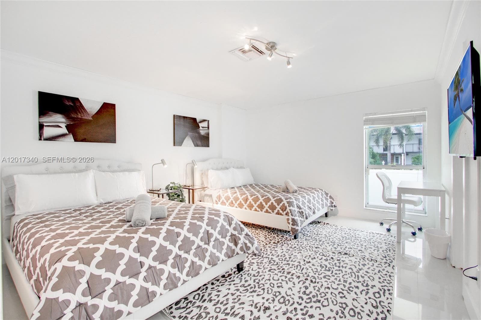 Neutral interior featuring polished tile flooring, recessed crown molding, and a multi-directional track light fixture