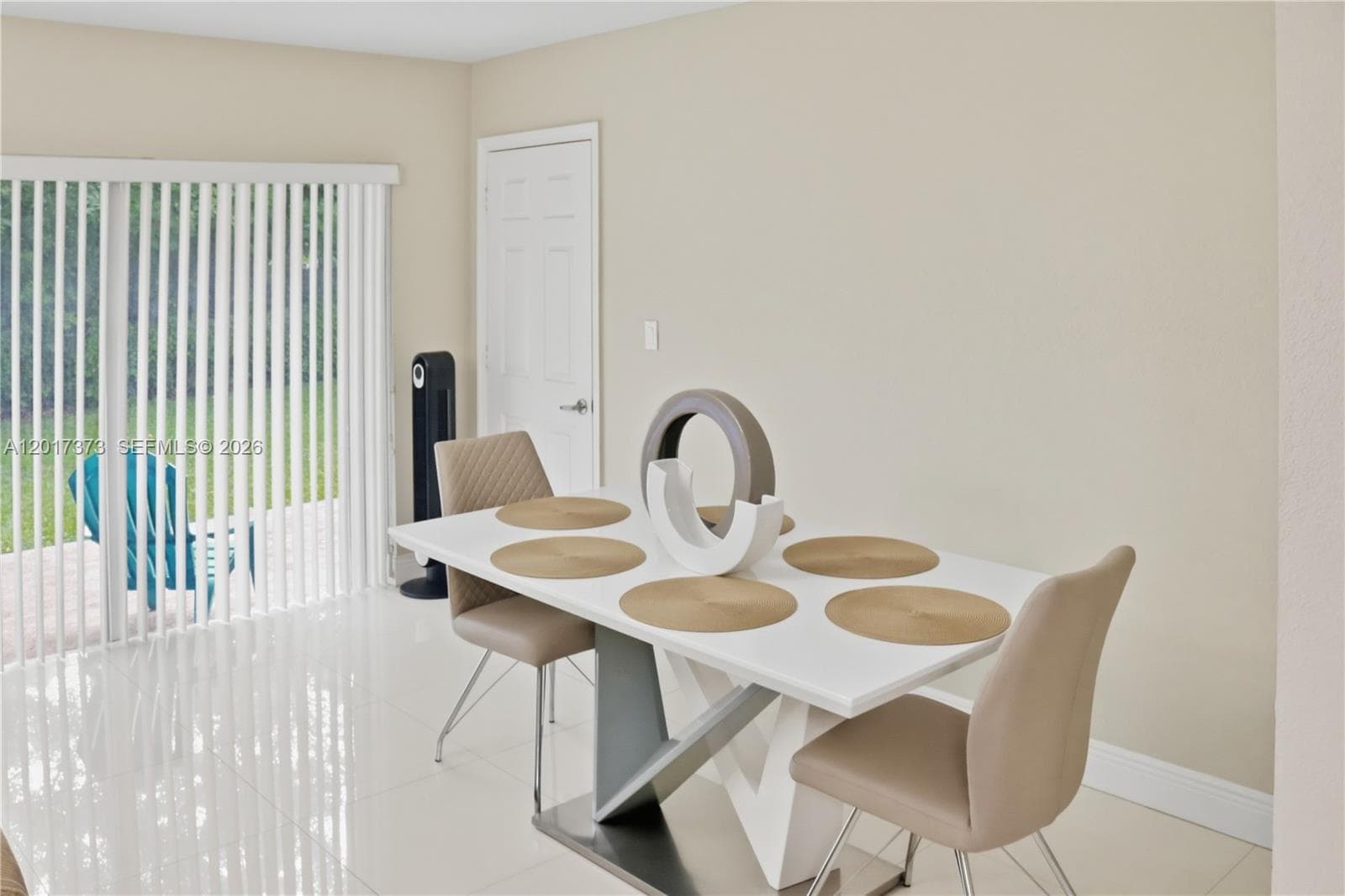 Backyard featuring a concrete patio, wood privacy fencing, a manicured lawn, and a detached exterior storage structure