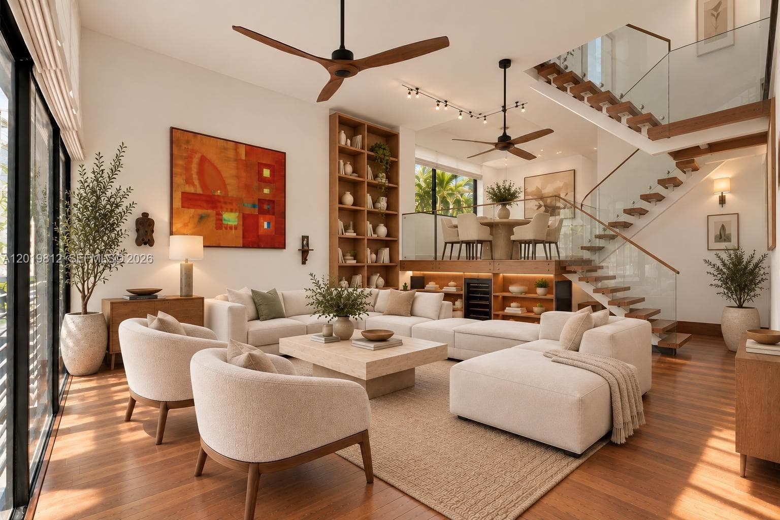 Open-concept interior featuring wood-finish flooring, a tiered floor plan, floor-to-ceiling built-in shelving, a glass-panel staircase with wood treads, and dual ceiling fans