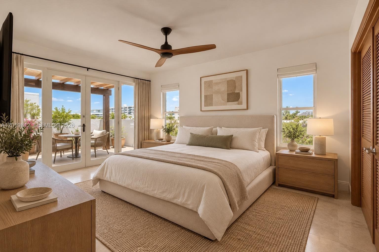 Bedroom featuring stone flooring, a three-blade ceiling fan, louvered closet doors, and glass-paneled double doors opening to a covered patio
