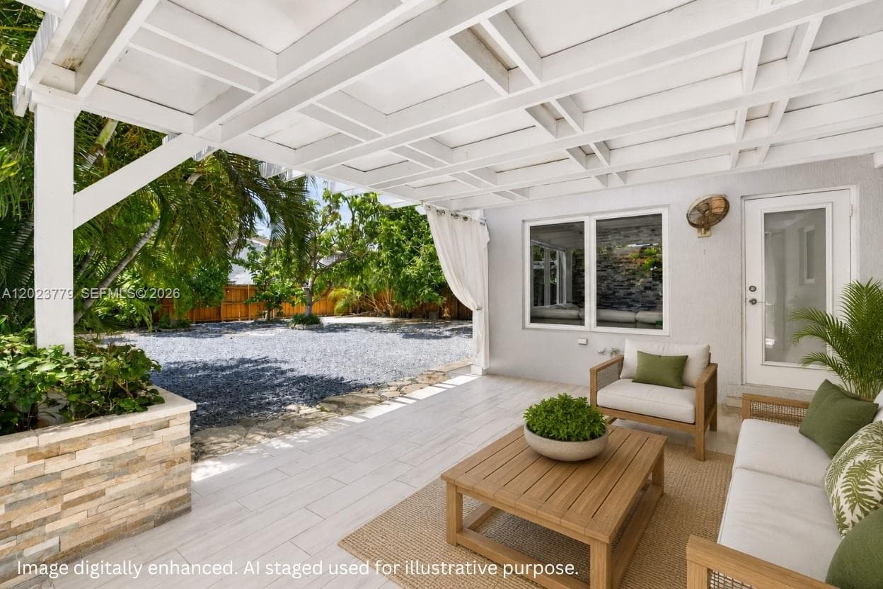 Covered Patio w/ tiled floor and stacked stone planter box. Virtually staged / enhanced