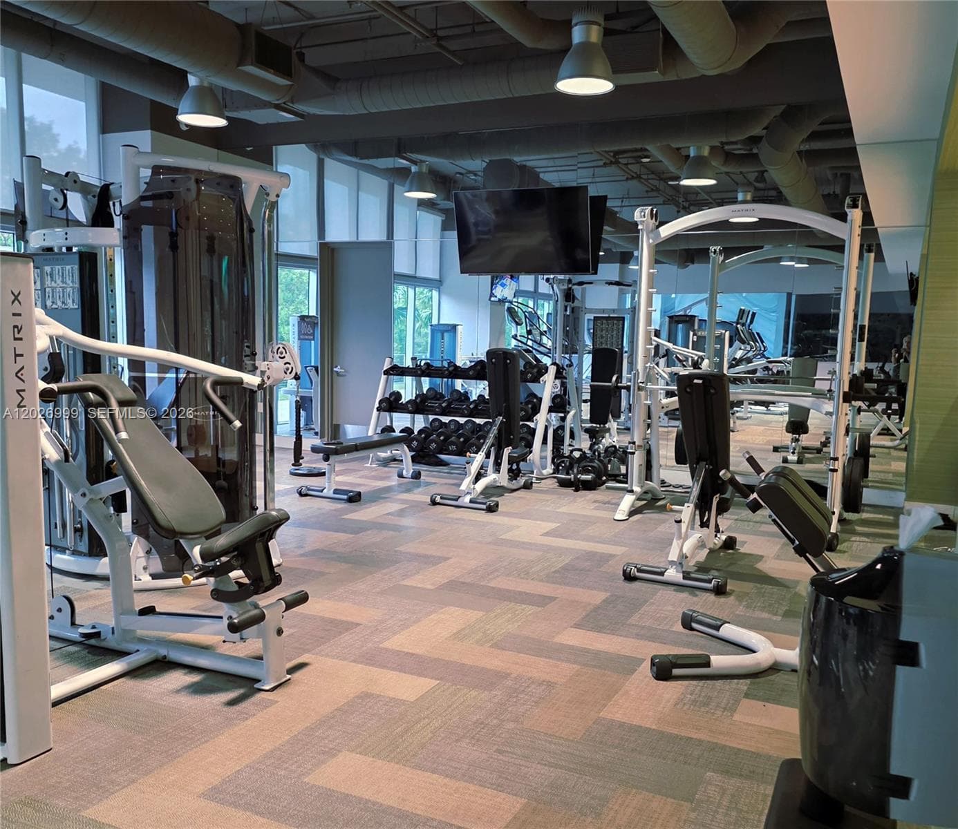 Stay active in the modern fitness studio, featuring high-end Peloton stationary bikes with a view of the facility's extensive amenities.