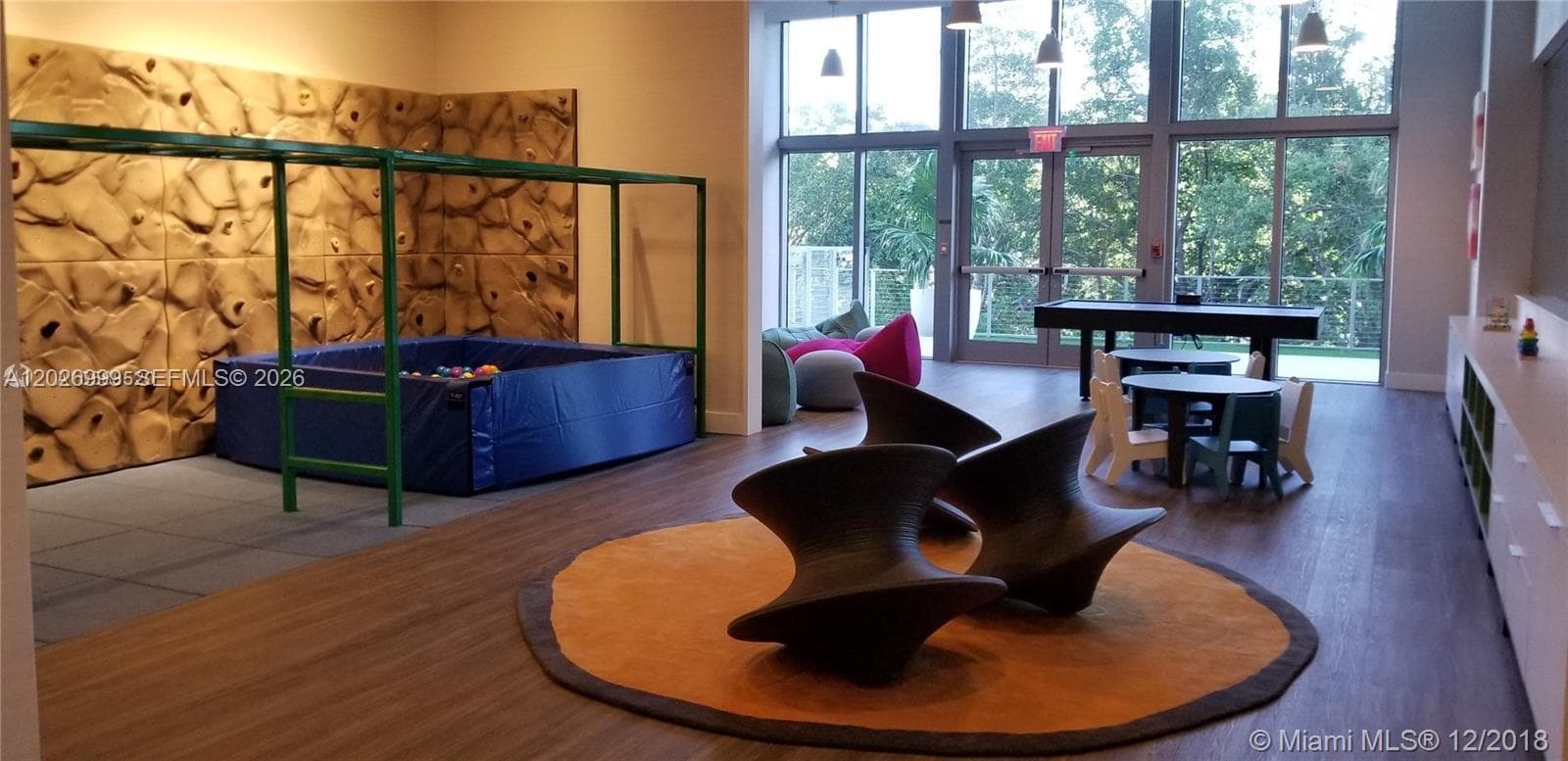 Dedicated children’s play area with slides and climbing structures under a shaded canopy, offering fun and comfort for all ages.
