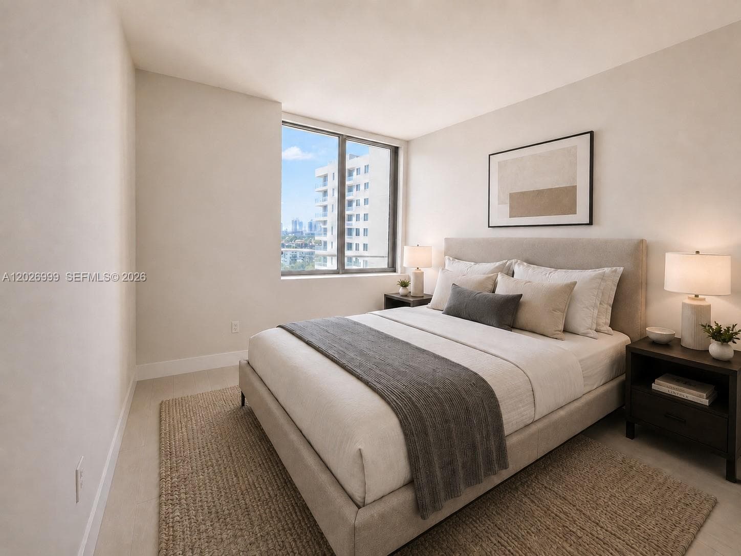 This bedroom features light tile flooring, neutral walls, and sliding glass doors that open to a private balcony with skyline and treetop views.