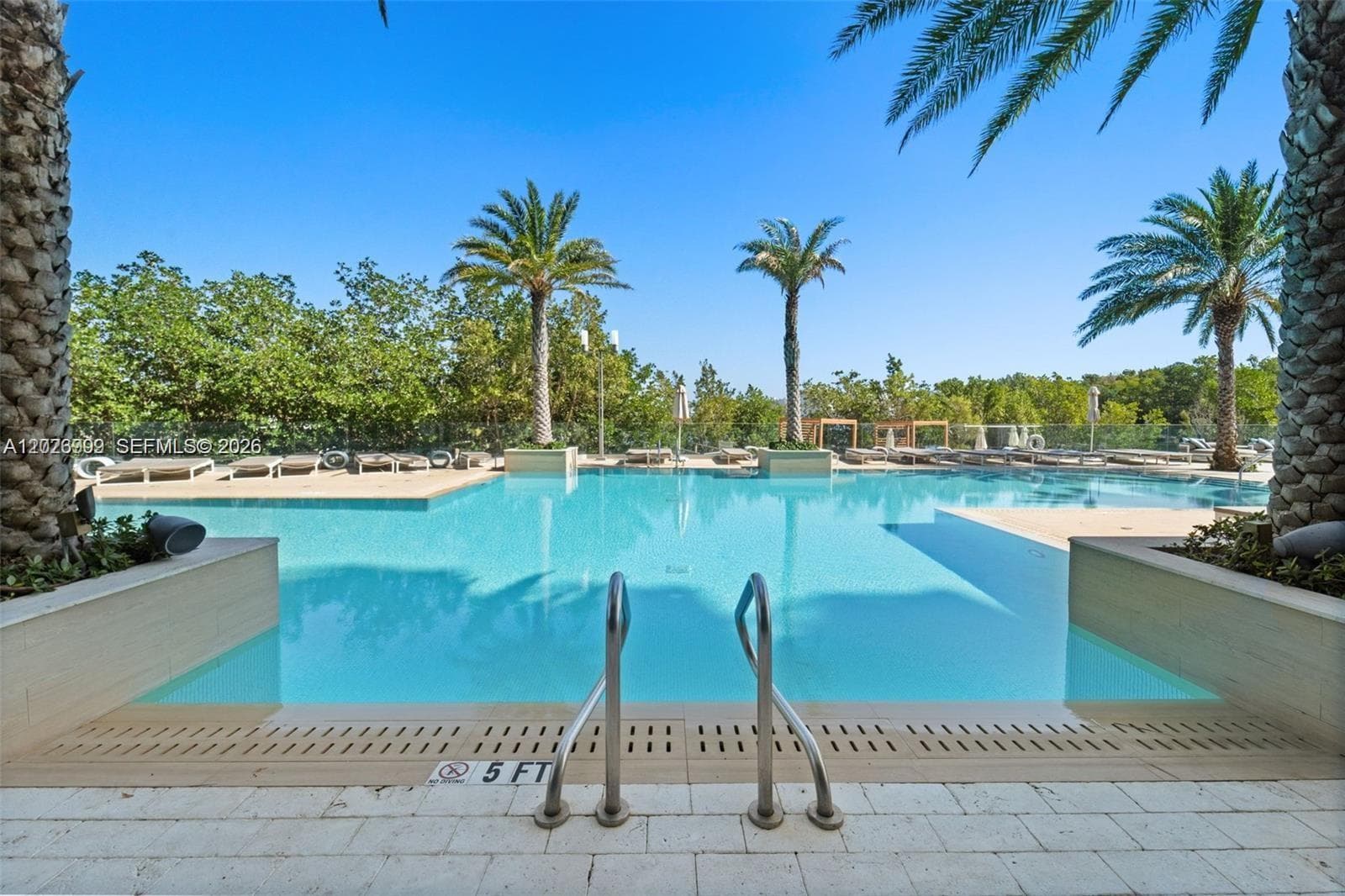 Striking twin-tower waterfront development surrounded by lush mangroves and shimmering bay waters, offering a sophisticated urban retreat with resort-style amenities.