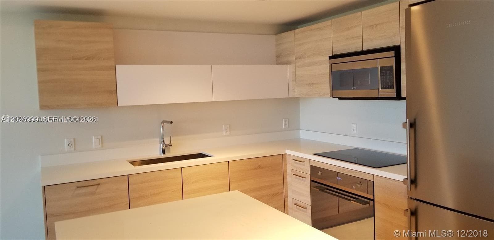 A flexible bedroom space with clean finishes, light flooring, and easy access to the adjacent closet and bath area.