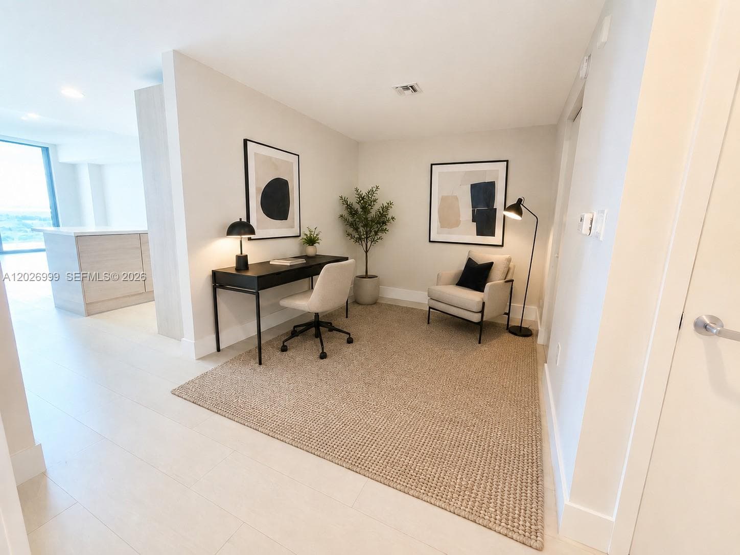 This bright bedroom features light tile flooring, neutral walls, and a built-in closet, offering a clean and flexible layout.