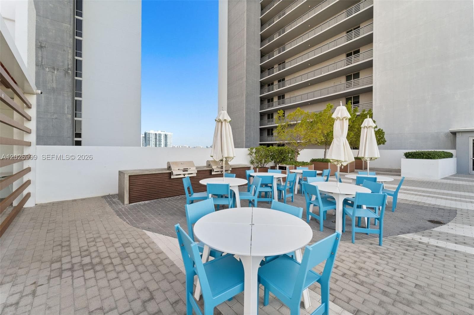 The elevated amenity area includes sports courts and open recreational spaces designed for active outdoor enjoyment.