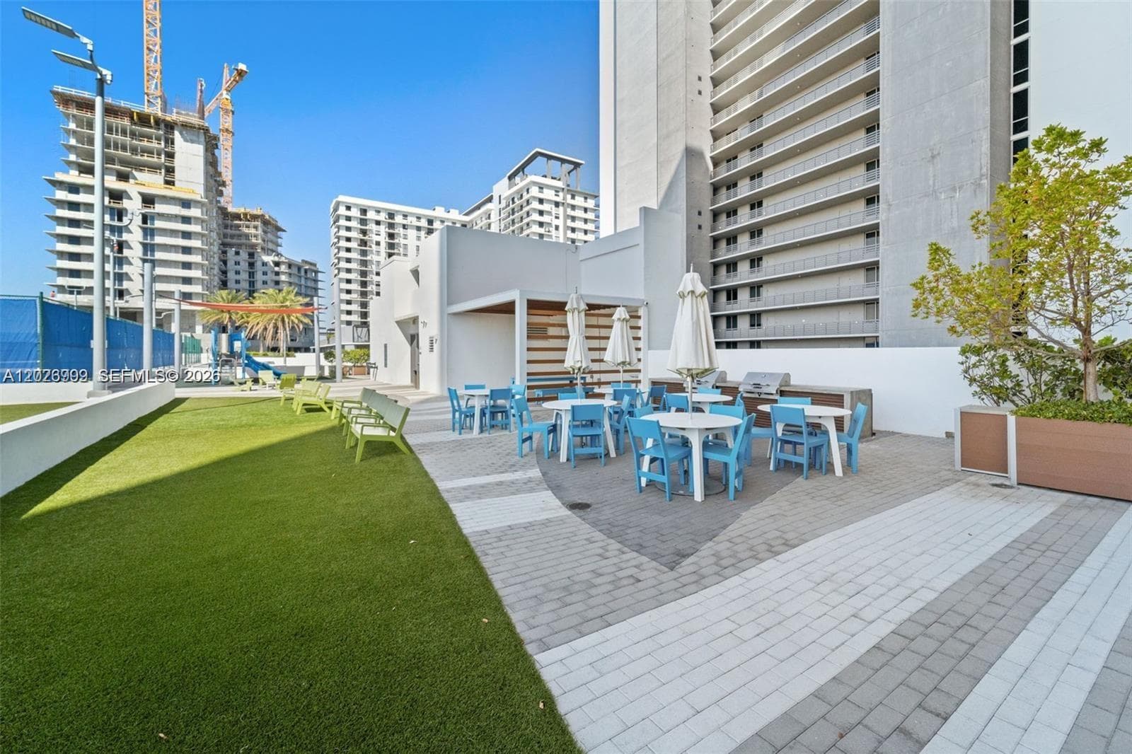 Multiple lounge chairs and shaded areas surround the pool, offering a comfortable setting for relaxing by the water.