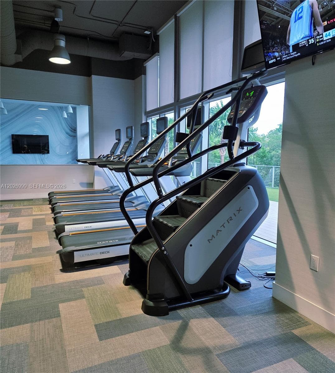 A professional-grade, glass-enclosed indoor court offers a versatile space for racquetball, handball, or other high-energy indoor activities.