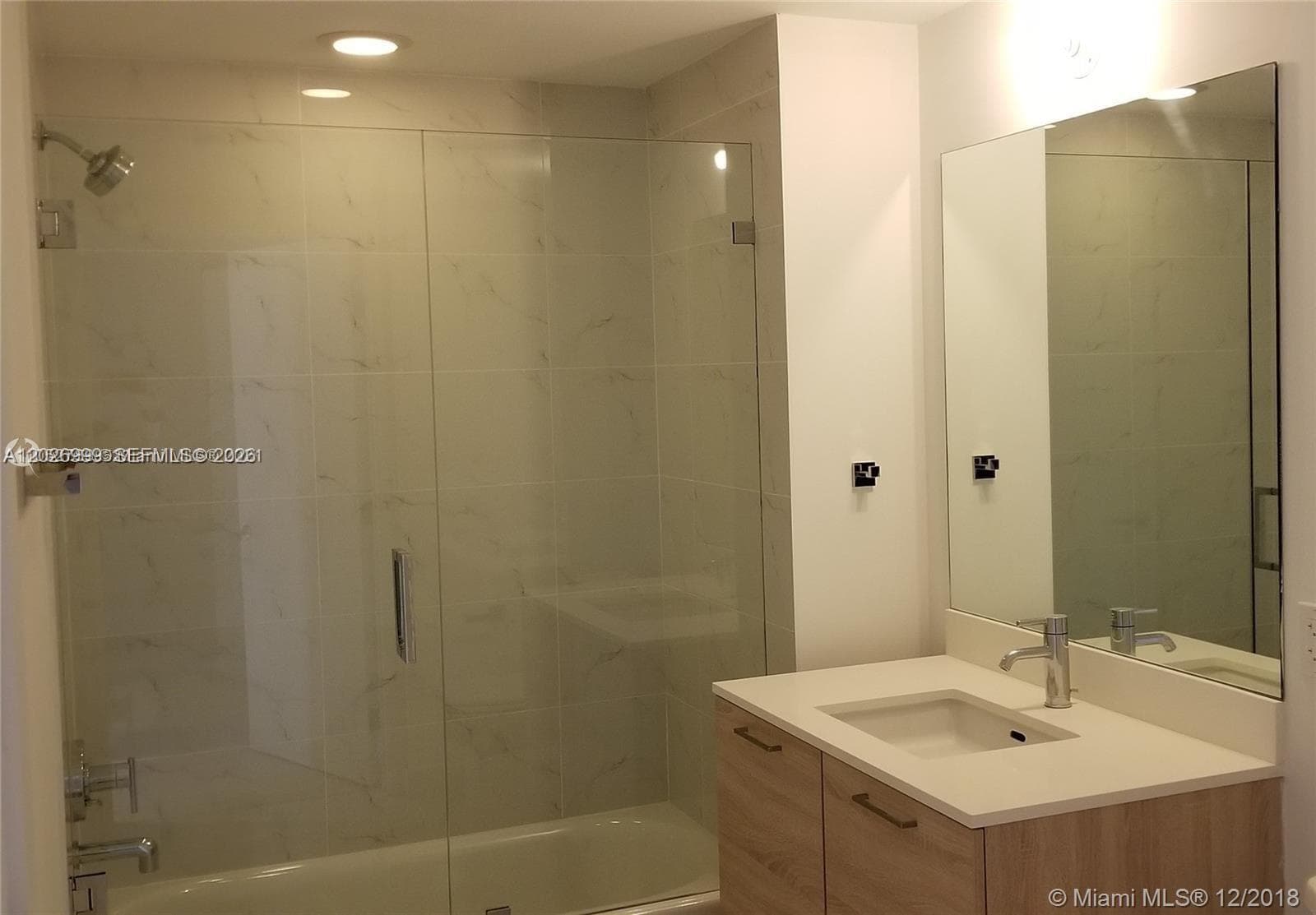 This secondary angle highlights the room’s clean lines, open wall space, and easy connection to the main living area and bath.