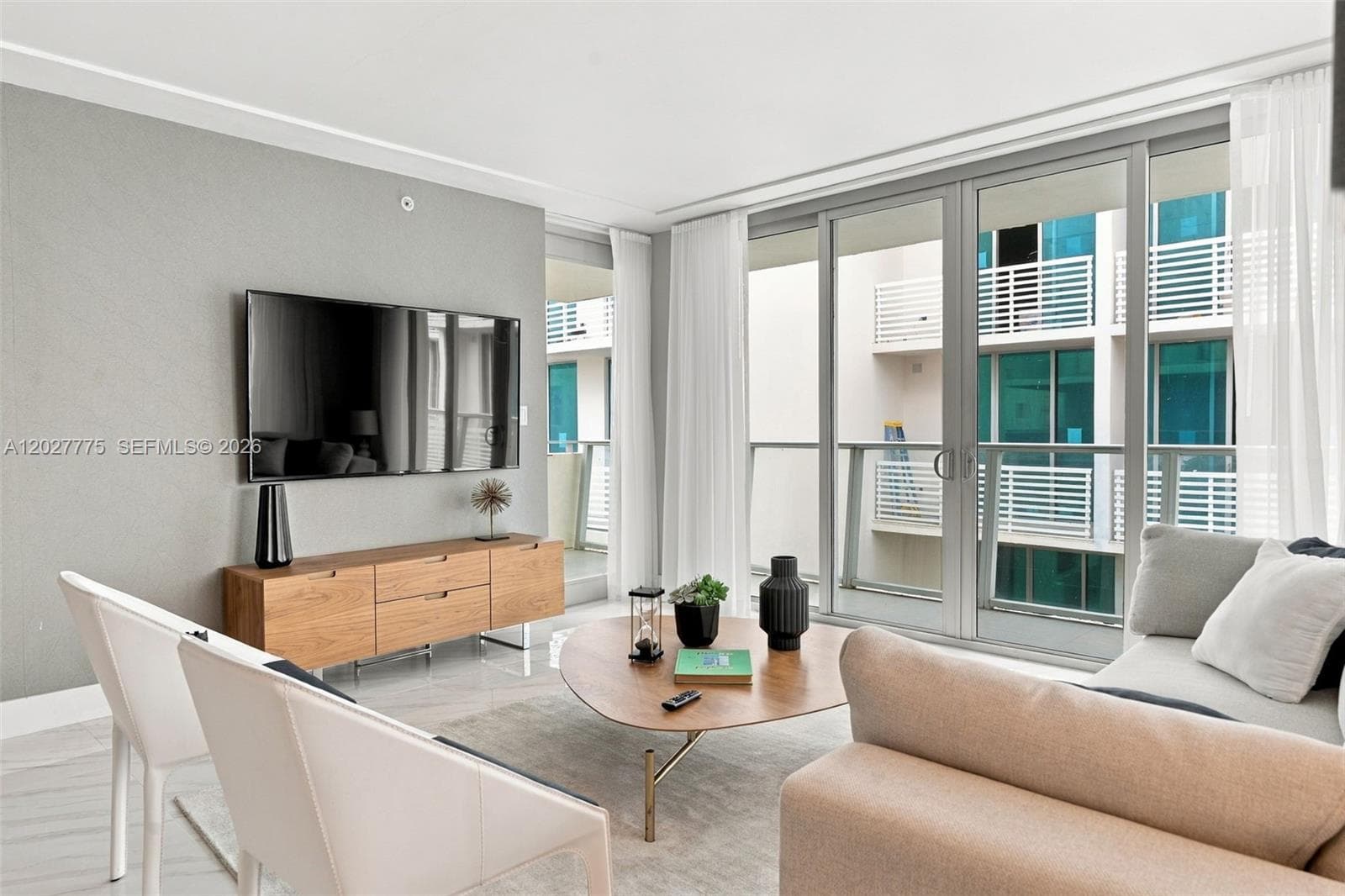 Living area featuring light gray wall finishes and light-toned flooring