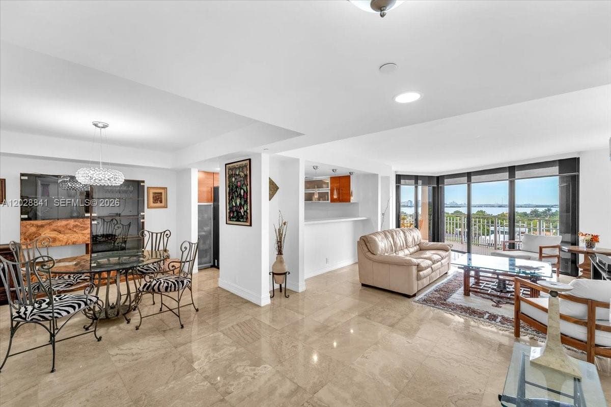 The living and dining area is spacious, open, and filled with natural light.
