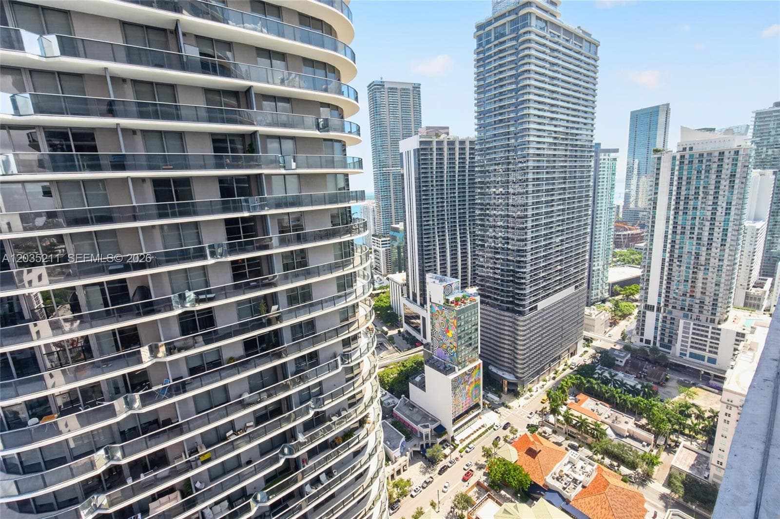 High-rise building featuring rounded exterior architecture with glass-railing balconies