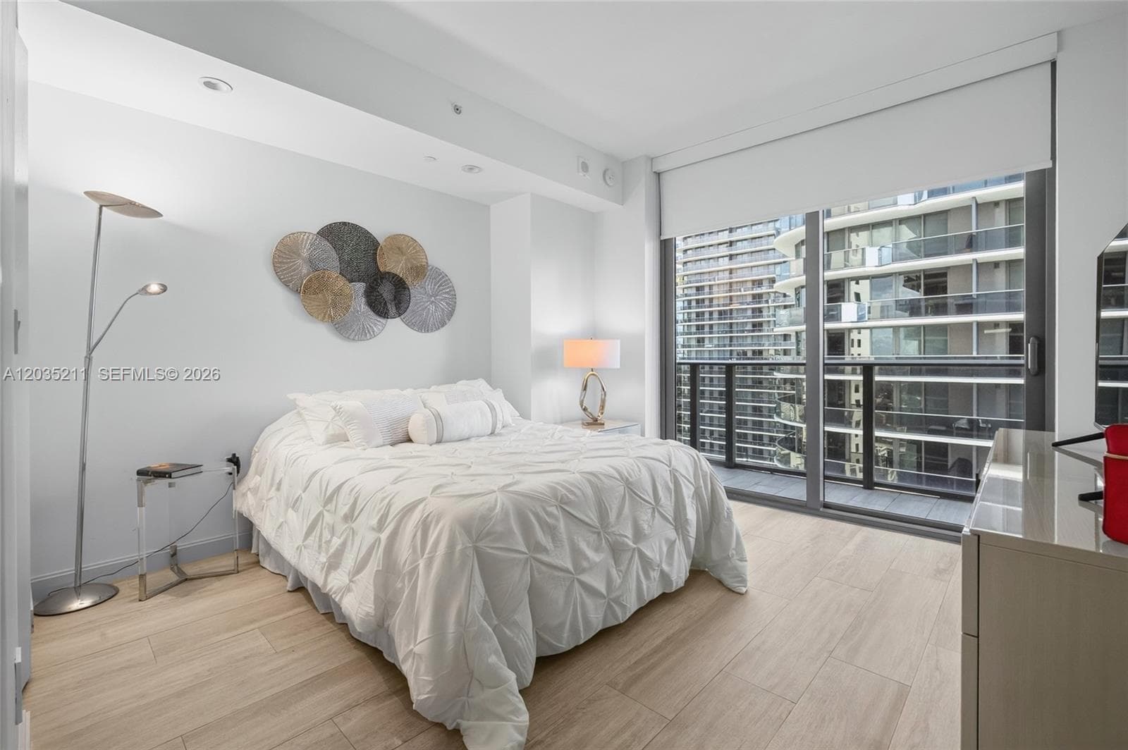 Wood-finish flooring, floor-to-ceiling glass door, private balcony, and recessed lighting