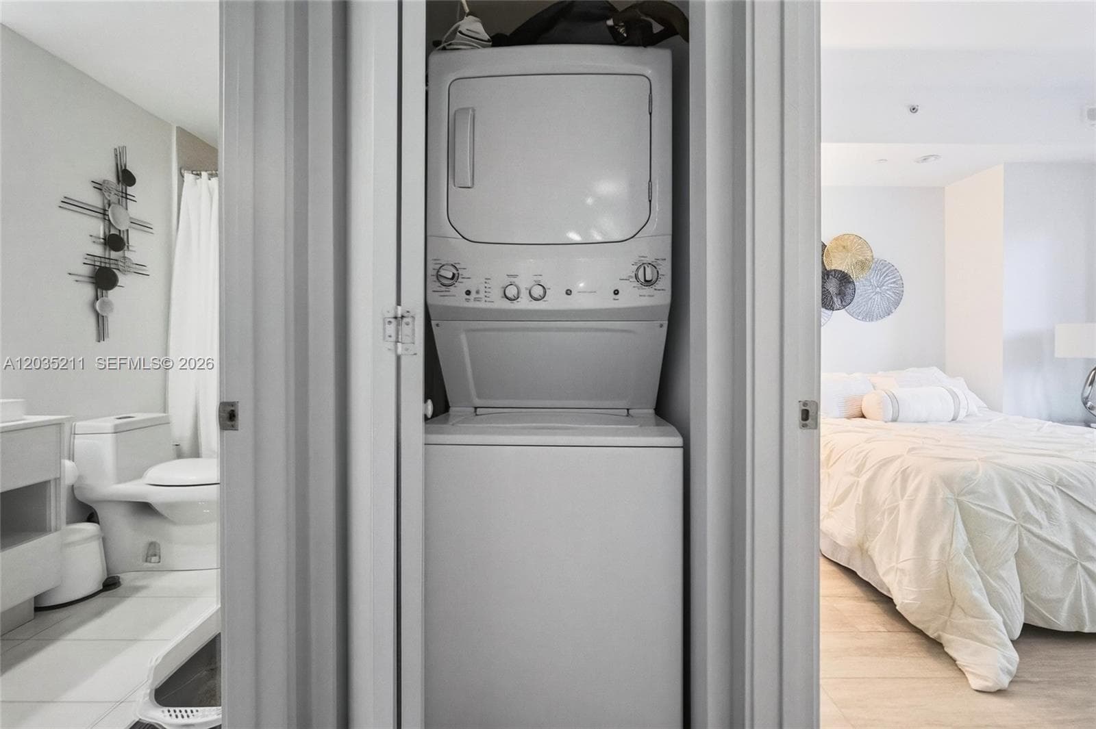 Stacked washer and dryer unit housed in a dedicated closet